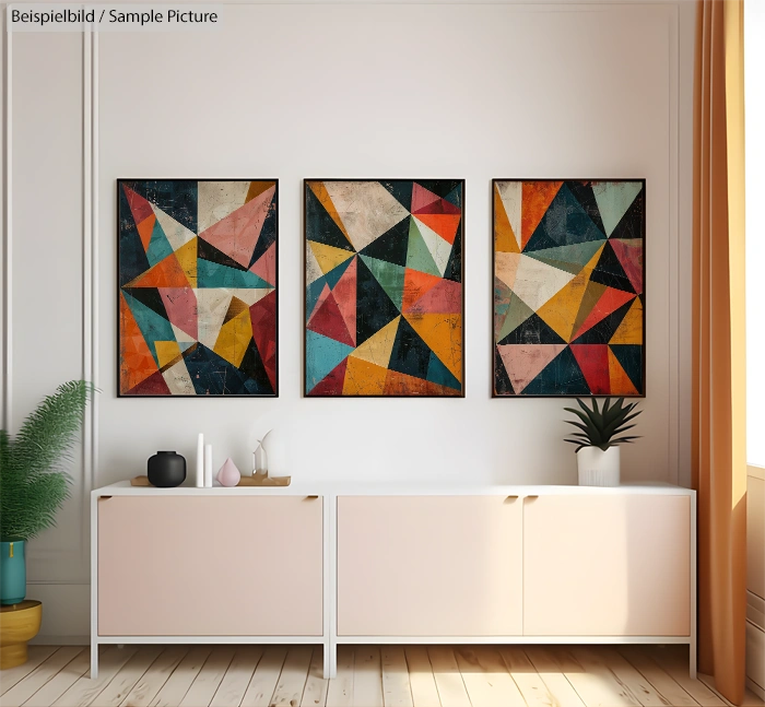 Living room with abstract geometric art on wall, light wood flooring, white console, potted plant, and orange curtains.