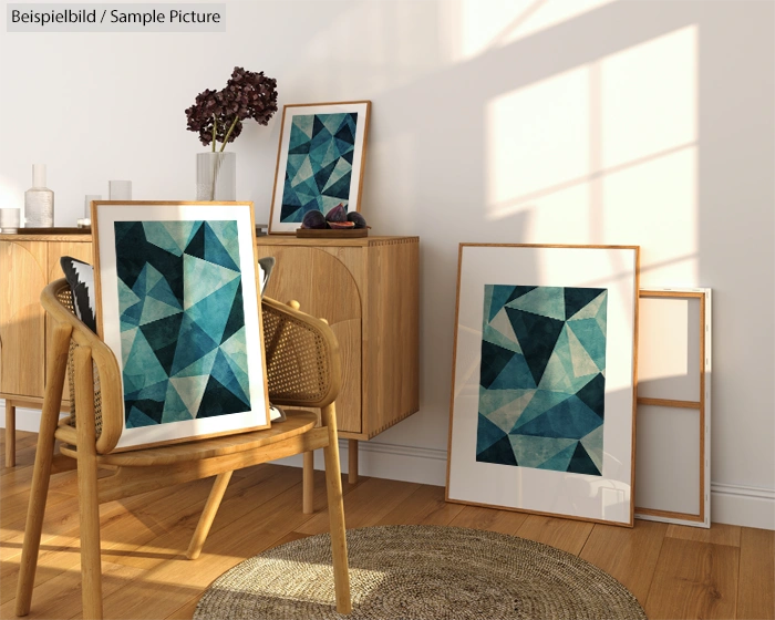 Modern living room with geometric art in blue hues, wood furniture, sunlight casting shadows on white walls.