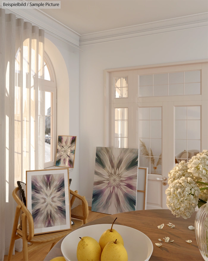 Elegant interior with abstract art, round table, pears, large window, and soft natural light.