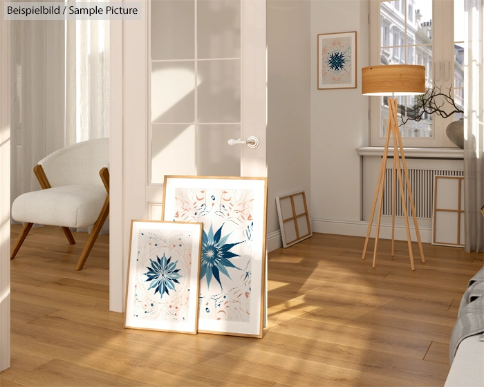 Sunlit room with wooden floor, two floral framed art prints, standing lamp, and a chair.