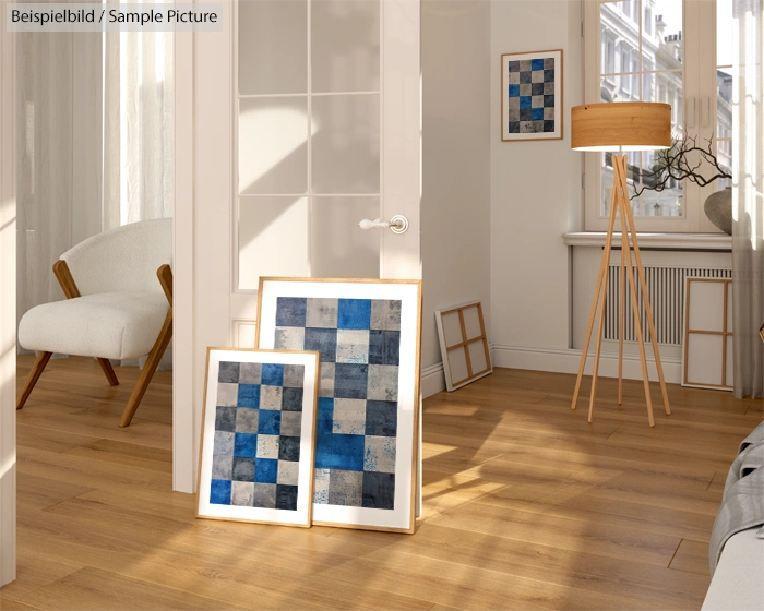 Bright living room with modern decor, featuring blue abstract art, wooden floor lamp, and sunlit hardwood flooring.