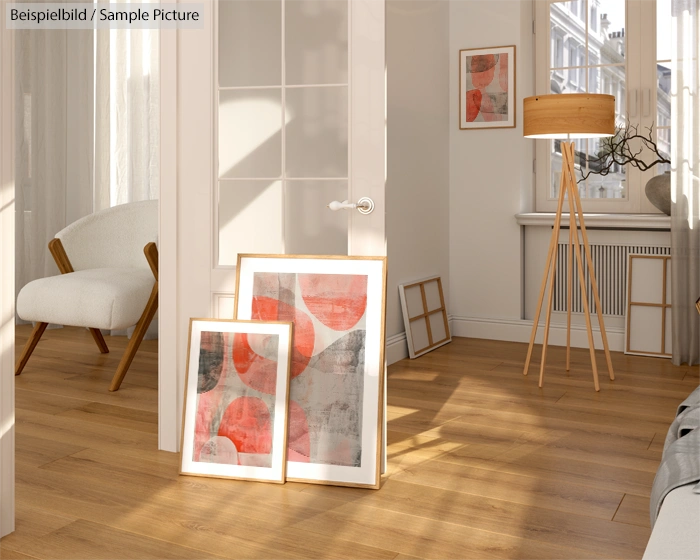 Modern living room with abstract red and gray artwork, wooden floor, armchair, and floor lamp.