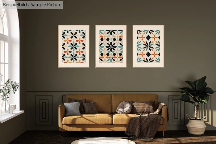 Modern living room with tan sofa, geometric art prints on wall, beige pillows, and a plant beside a tall window.