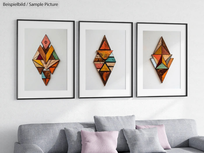 Living room with modern geometric artwork and gray sofa, cushions in light hues, and three framed colorful prints.