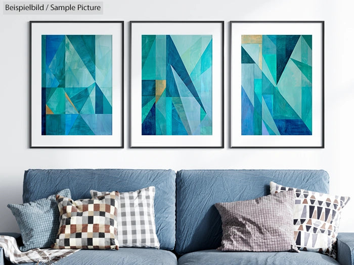 Abstract teal geometric art triptych on wall above grey sofa with patterned pillows.