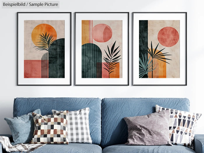 Set of three framed abstract art prints with geometric shapes and palm motifs above a blue sofa.