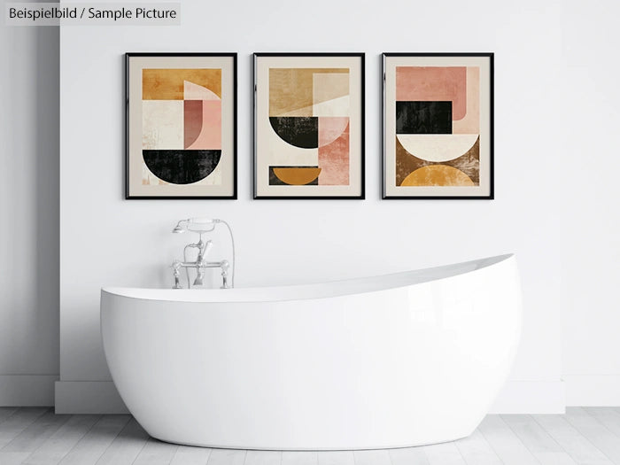 Modern bathroom with a sleek white bathtub and three abstract geometric paintings on the wall.