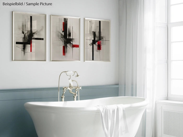 Modern bathroom with freestanding white tub, towel draped over edge, and abstract art on wall above.