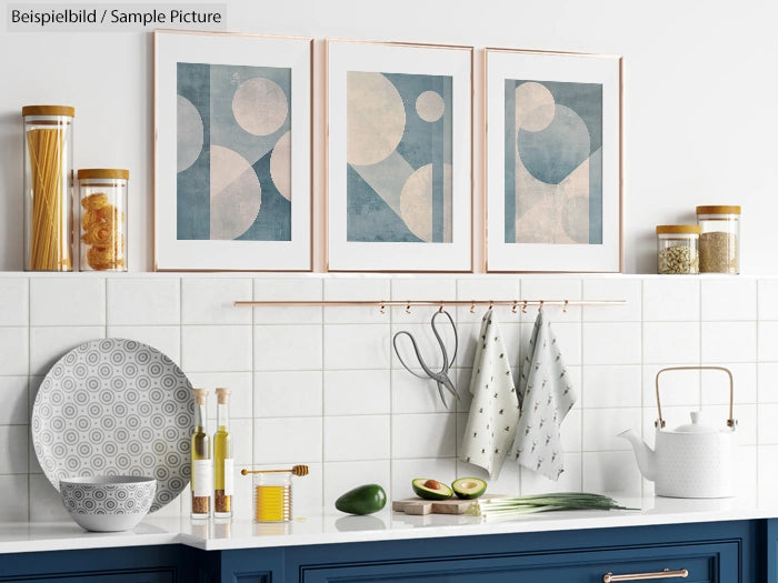 Modern kitchen with abstract art, blue cabinets, and neatly arranged utensils and ingredients on a tiled backsplash.