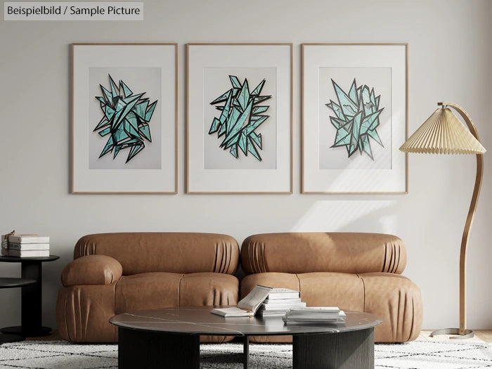 Modern living room with tan leather sofa, round coffee table, and abstract art framed on wall.