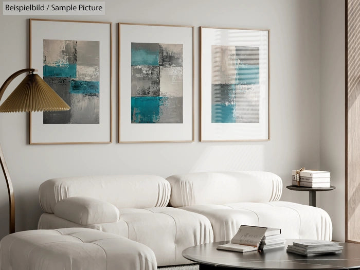 Modern living room with white sofas and abstract turquoise art on the wall, featuring natural light through a window.