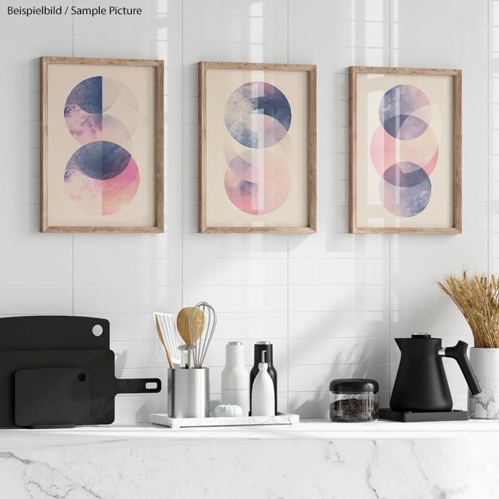 Modern kitchen with white tiles, black kettle, utensils, and abstract art on the wall.