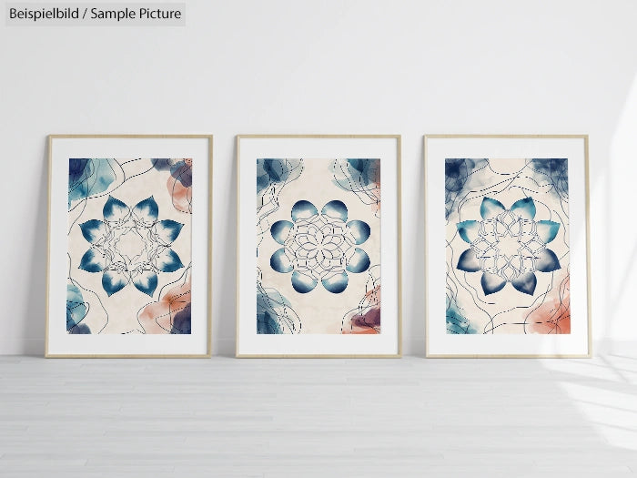 Three framed abstract flower prints with blue and coral hues on a white wall, displayed in a minimalist setting.