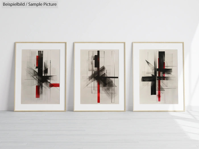 Three framed abstract prints featuring geometric black and red shapes on gray backgrounds, displayed against a white wall.