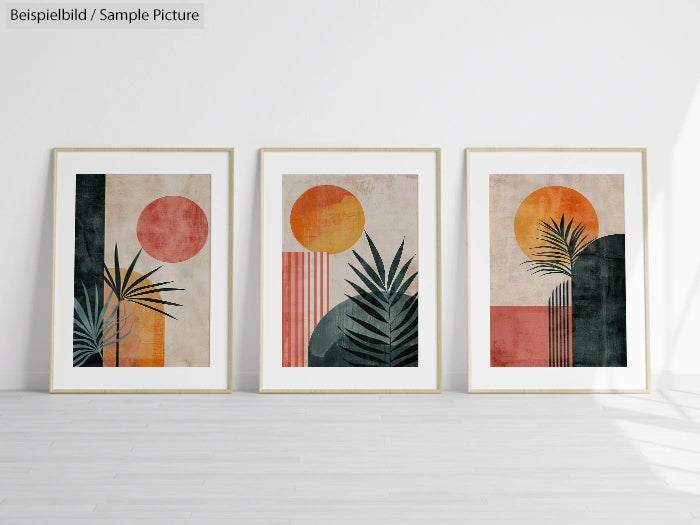 Set of three framed abstract prints with plants, sun motifs, and geometric shapes in earthy tones against a white wall.