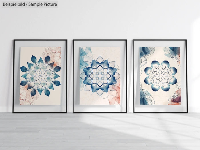 Three framed abstract floral prints in blue and beige hues displayed on a minimalist white wall.