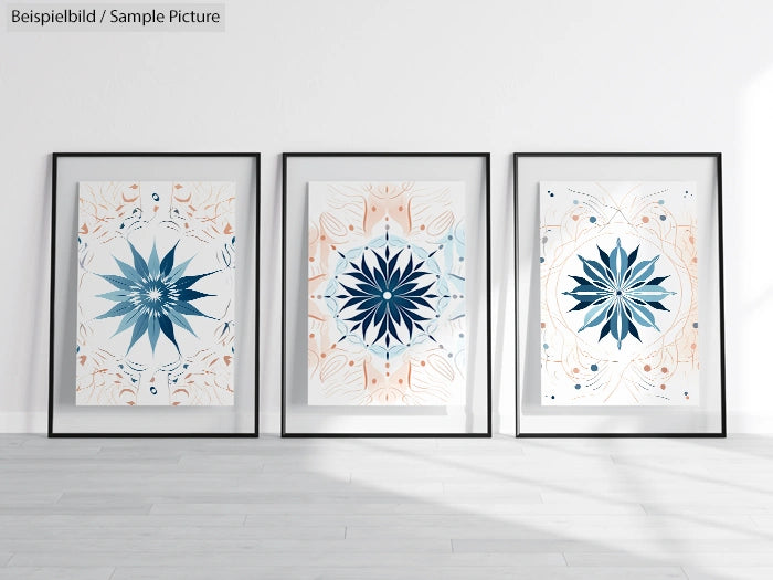 Framed geometric flower artworks in blue and orange tones on a minimalist interior wall.