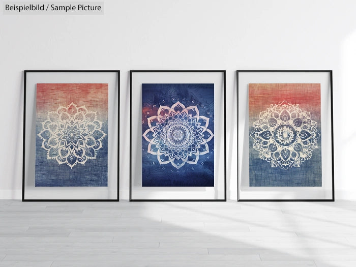 Three framed mandala art prints in a white room, featuring intricate designs in blue and red hues.