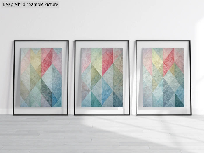 Three framed abstract paintings with colorful geometric patterns against a white wall.