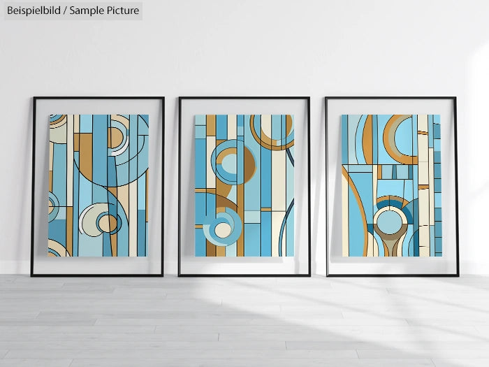 Three framed abstract art prints with blue and gold geometric patterns on a white wall.