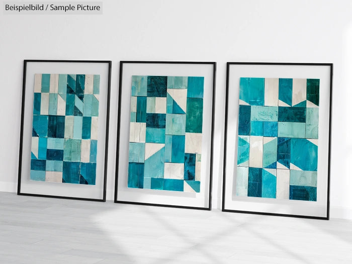 Three framed abstract paintings with blue and teal geometric patterns on a white wall.