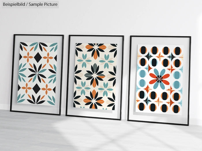 Three framed abstract geometric prints with colorful floral and circular patterns, displayed against a white wall.