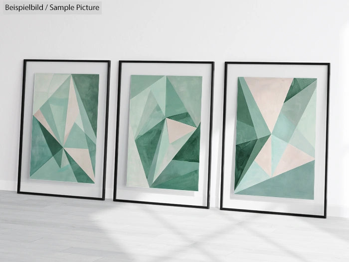 Three framed abstract geometric paintings with teal, green, and beige triangles on a white wall.