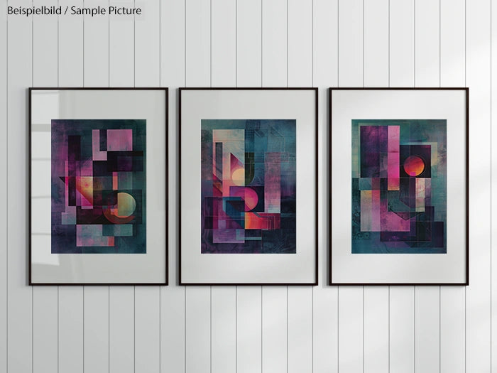 Three abstract geometric art pieces in frames on a white wall, featuring vivid pinks, purples, and blues.