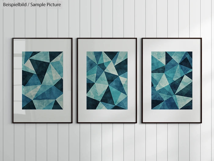 Three framed abstract geometric artworks with blue and teal shades, hanging on a white paneled wall.