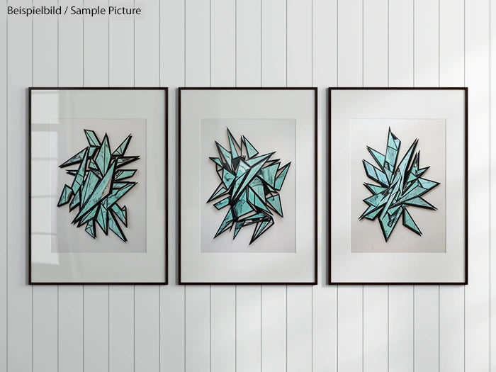 Three framed abstract artworks with sharp turquoise geometric shapes on a white wood-paneled wall.