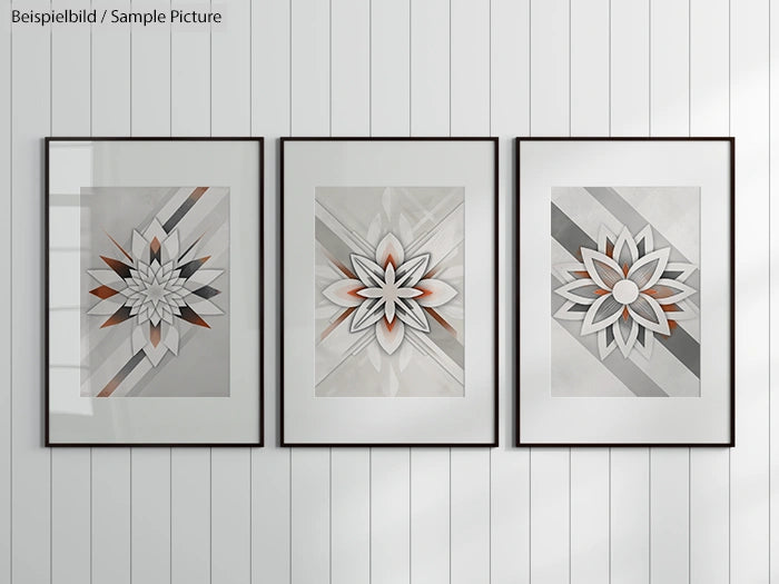 Three framed geometric flower art prints on a white paneled wall.