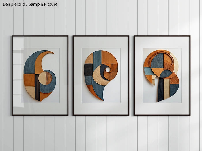 Triptych of abstract wood designs in shades of blue, orange, and beige, framed on a white paneled wall.