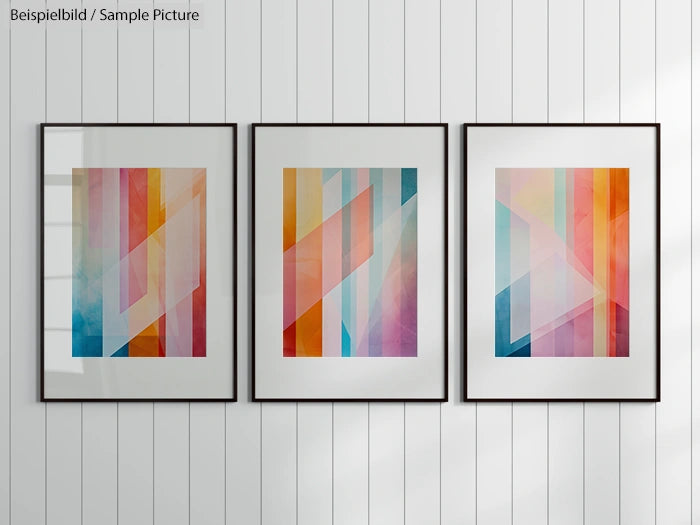 Abstract geometric art prints in frames on a white paneled wall.