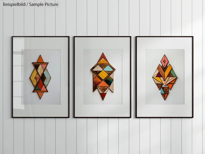 Three framed geometric abstract artworks with colorful patterns on a white-panelled wall.