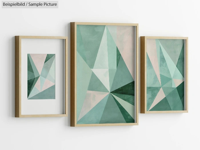 Trio of framed geometric art prints with overlapping green and white triangles on a white wall.