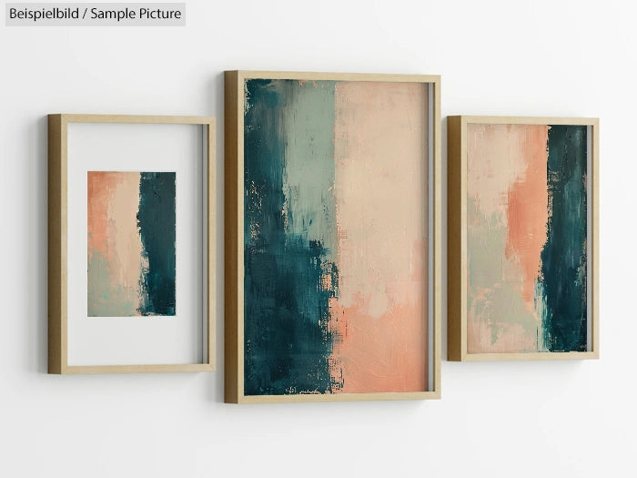 Triptych abstract paintings with teal and peach brushstrokes in wooden frames on a white wall.