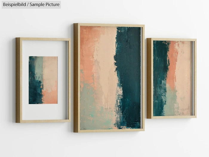 Triptych artwork with abstract teal, peach, and beige brushstrokes in wooden frames against a white wall.