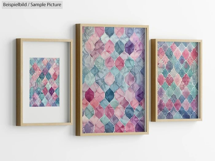 Three framed watercolor art pieces with geometric patterns in pastel colors on a white wall.