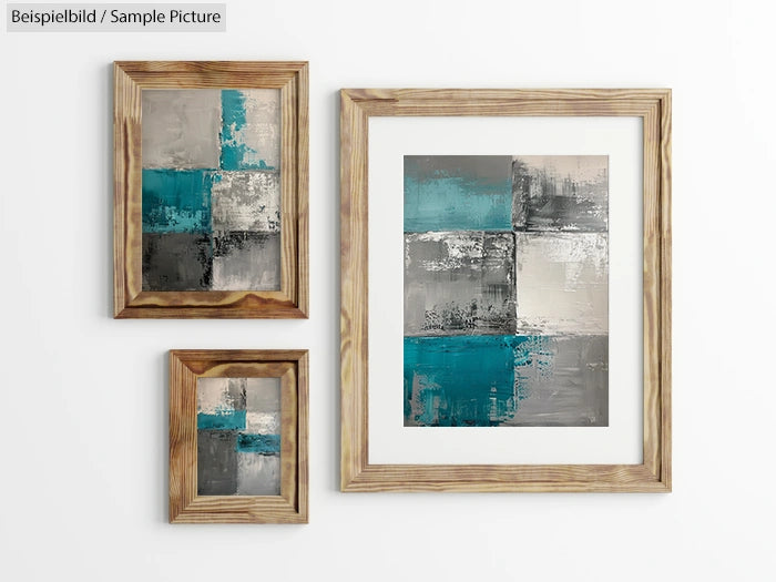 Three abstract paintings with teal, gray, and white colors in wooden frames on a white wall.