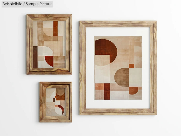 Three wooden-framed geometric abstract artworks on a white wall, featuring beige, brown, and red shapes.