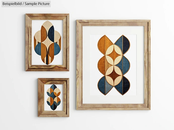 Three framed geometric artworks with blue, orange, and cream patterns on a white wall.