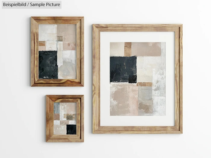 Three framed abstract paintings with beige, black, and white geometric patterns on a white wall.