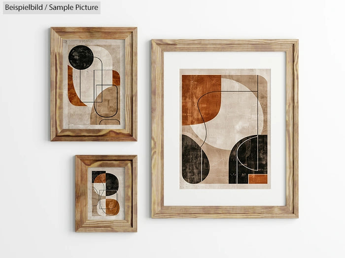 Three abstract geometric paintings in wooden frames on a white wall.