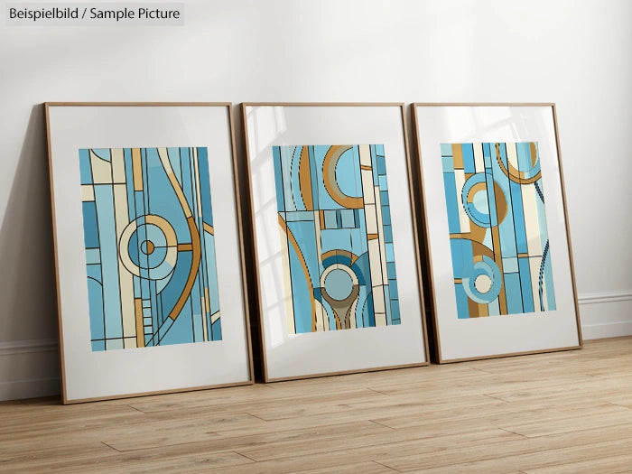 Set of three abstract geometric paintings with blue and orange designs in frames on wooden floor.