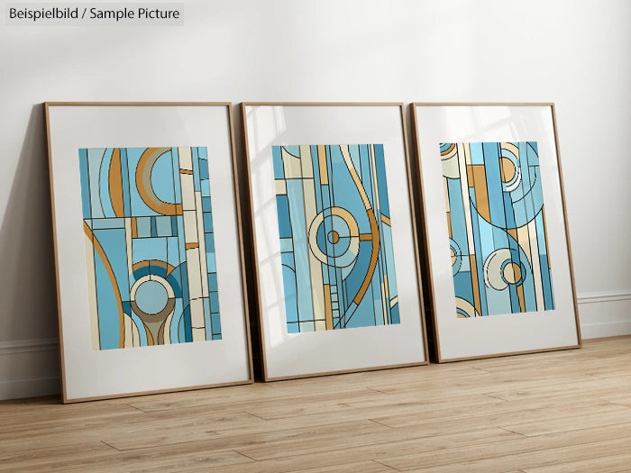 Three framed abstract paintings with blue, beige, and orange geometric patterns leaning against a wall on wooden floor.