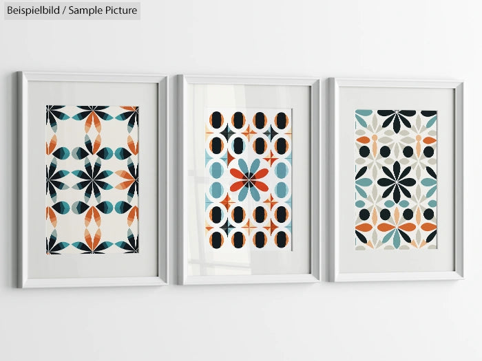 Set of three framed geometric art prints with orange, blue, and black patterns on a white background.