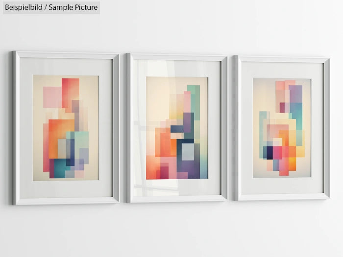 Triad of framed abstract artworks with pastel colored geometric shapes on a white wall.