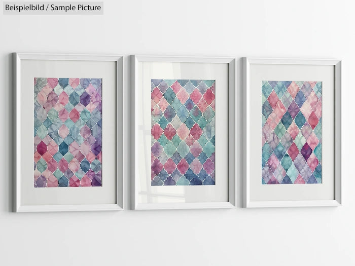 Three framed abstract paintings with colorful geometric patterns displayed on a white wall.